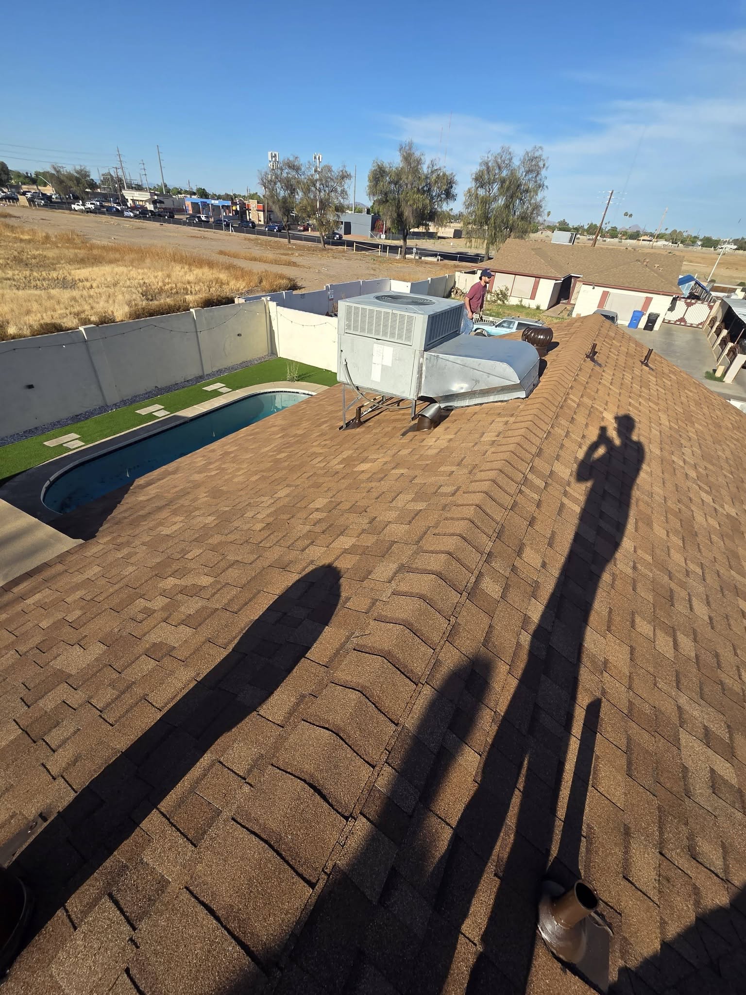 Brown asphalt shingle roof and rooftop equipment.